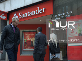 People passing each other outside a branch of Santander. (