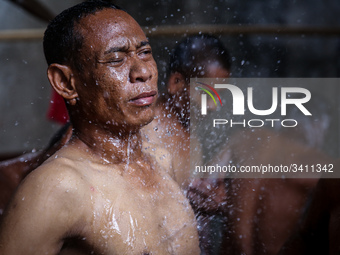 A mental patient reacts as he is given a shower at the Jamrud Biru foundation house in East Bekasi near Jakarta, Indonesia, on Saturday, Nov...