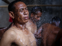 A mental patient reacts as he is given a shower at the Jamrud Biru foundation house in East Bekasi near Jakarta, Indonesia, on Saturday, Nov...