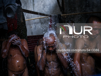 Mental patient reacts as they is given a shower at the Jamrud Biru foundation house in East Bekasi near Jakarta, Indonesia, on Saturday, Nov...