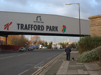 A man walking his dog in to the Trafford Park industrial estate in Trafford, Greater Manchester. (
