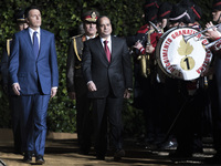 Italian Prime Minister Matteo Renzi (L) and Egyptian President Abdel Fattah al-Sisi prepare to review a guard of honor upon al-Sisi's arriva...