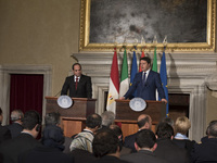 Egyptian President Abdel Fattah al-Sisi (L) and Italian Prime Minister Matteo Renzi shake hands during a news conference following their mee...