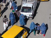 Afghan burqa clad women walk along a road in capital Kabul, Afghanistan on November 25, 2014. According to media reports, despite the progre...