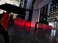 Pedestrians walk under umbrellas on a rainy night in downtown Sao Paulo, Brazil on Tuesday, November 25, 2014. Lately, rain is long overdue...