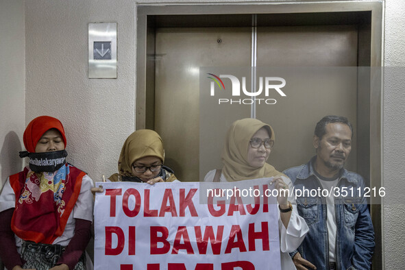 Jakarta, Indonesia, 04 December 2018 : Employee of Antara news Agency that were paid under minimum wage with banner said 