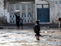 woman walks the street during rain 'has hit Gaza very low in the past 3 days and so far(