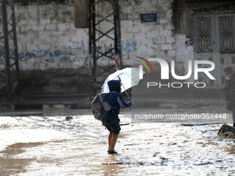 Children returning from school who walks the street during rain 'has hit Gaza very low in the past 3 days and so far(