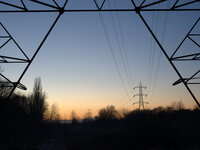 Electricity transmission lines silhouetted against the light of the setting sun on December 5, 2014 in Stockport, England, UK.
(