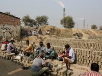 Brick field workers are eating lunch after his work shift in brickfields Narayanganj near Dhaka Bangladesh on January 12, 2019 (