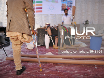 70yrs old Sher Bahadur Mahadev observes newly Artificial Limb to be fitted to Nepalese people during Artificial limb fitment camp in Norvic...