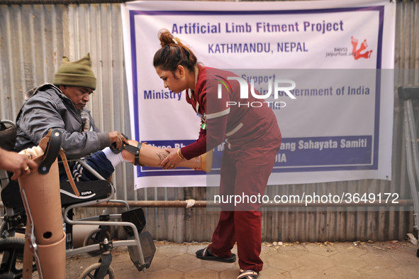 A Nurse helps to fit artificial Prosthetic legs during Artificial limb fitment camp in Norvic International Hospital, Kathmandu, Nepal on Su...