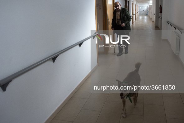 Miko accompanies an old man through the corridors of the San Cipriano Residence in Soto de la Marina, Cantabria, Spain, on 16 January  in on...