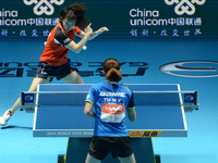 Seo Hyowon of South Korea (Top) competes with Yu Mengyu of Singapore during Women's single semi-final round of the 2014 ITTF World Tour Gran...