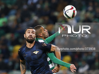 Sporting's forward Islam Slimani (L) heads for the ball with Moreirense's defender Marcelo Oliveira (R)  during the Portuguese League  footb...
