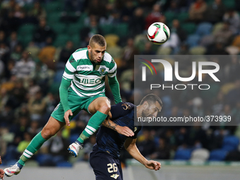 Sporting's forward Islam Slimani (L) heads for the ball with Moreirense's defender Marcelo Oliveira (R)  during the Portuguese League  footb...
