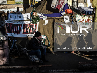 Man sits in front of the army tent on Kiev's Independence Square.

Photo: Sergii Kharchenko/NurPhoto