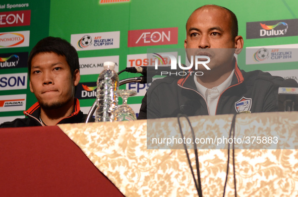 Thailand assistant coach Choketawee Promrut (R) addresses during a press conference of the AFF Suzuki Cup 2014 final round 1st leg Thailand...
