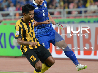 Shukor Adan of Malaysia (L) vies with Peerapat Notchaiya of Thailand during the AFF Suzuki Cup 2014 final round 1st leg Thailand - Malaysia...