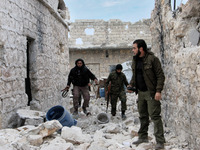 Rebels walk in the front lines of Handarat, in Aleppo, Syria, on December 18, 2014. (
