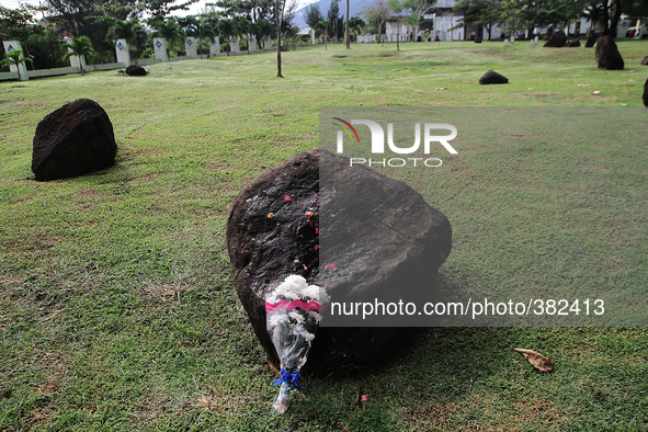 Flowers lay on the grave stone as a prayer for friends and family Acehnese people who died as a result of the Indian Ocean tsunami struck in...