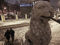 People walking on Bridge of Four Lions during snowfall in St.Petersburg, Russia, 28 December 2014 (