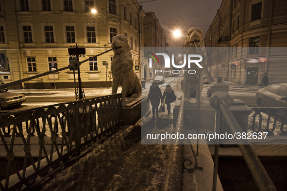 People walking on Bridge of Four Lions during snowfall in St.Petersburg, Russia, 28 December 2014 