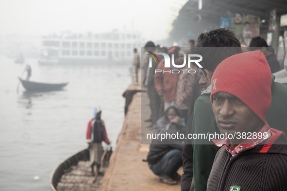 Some people are waiting for their ferry at Sadarghat, Dhaka, Bangladesh on 29th September 2014. Due to heavy fog the ferry couldn't reach at...