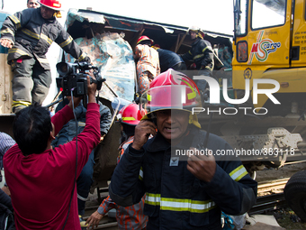 A rescue worker were busy at the accident site on December 28, 2014 in Dhaka, Bangladesh. (