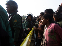 Police were busy in controlling the mass people at the accident site on December 28, 2014 in Dhaka, Bangladesh. (