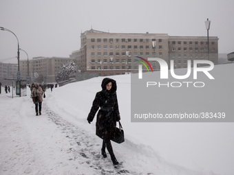 A woman wades through the snow near the metro station Derzhprom, in Kharkov, Ukraine, on December 30, 2014. (