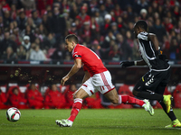 Benfica's forward Lima (L) vies with Nacional's defender Zainadine Junior during the Portuguese League Cup  football match between SL Benfic...