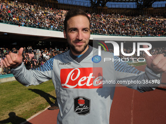Gonzalo Higuain poses with the Supercoppa during training and presentation on Supercup Supercoppa won in Doha at San Paolo Stadium on August...