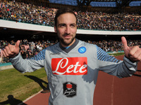 Gonzalo Higuain poses with the Supercoppa during training and presentation on Supercup Supercoppa won in Doha at San Paolo Stadium on August...