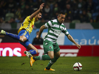Estoril's forward Kleber (L)  vies with Sporting's defender Jefferson during the Portuguese League  football match between Sporting CP and E...