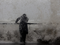 A storm makes its way across Israel, with strong winds, rain, and snow fall in parts of the country.A person watches as waves crash on the M...