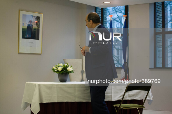 The Tunisian ambassador to The Netherlands, Mohamed Ben Becher is seen signing the condolence registry in the French embassy in The Hague on...