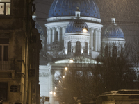 Man with a dog walks near of Trotsky Cathedral during a heavy snowfall in Saint Petersburg, Russia, 08 January 2015. (