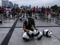 Volunteer arrange Panda sculptures during the 1,600 Pandas World Tour at National Monument in Kuala Lumpur, Malaysia on January  9, 2015. Th...