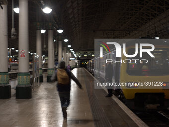 A person running towards a train about to depart Manchester Piccadilly station. (