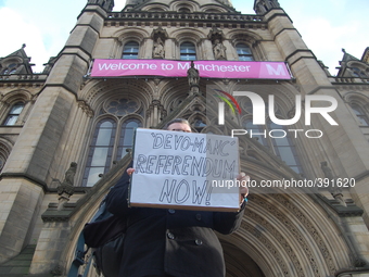 A campaigner holding a placard which is calling for a referendum on 