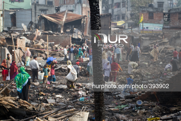 Victims were working to fix their houses and to find essentials from the remains of the gutted Poolpar Slum  on January 13, 2015 in Dhaka, B...