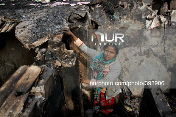 Victims were working to fix their houses and to find essentials from the remains of the gutted Poolpar Slum  on January 13, 2015 in Dhaka, B...