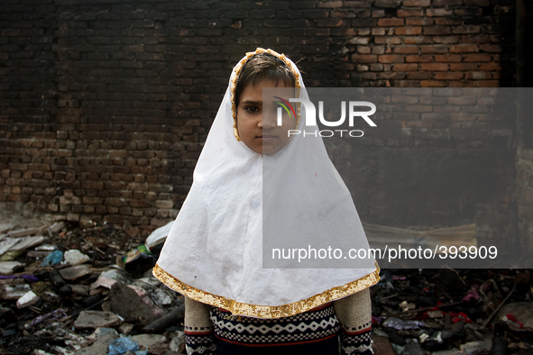 A child standing amid the remains of the gutted Poolpar Slum on January 13, 2015 in Dhaka, Bangladesh. 