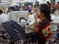A seamstress making clothing at a garment factory in Bangalore. Many of the workers emigrate from poor regions of the country, making clothe...