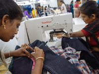 Seamstresses making clothing at a garment factory in Bangalore. Many of the workers emigrate from poor regions of the country, making clothe...