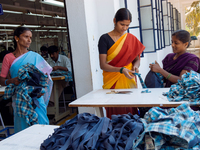 Workers making clothing at a garment factory in Bangalore. Many of the workers emigrate from poor regions of the country, making clothes to...