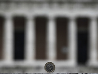 One-euro coin with the Greek Parliament on the background in Athens on January 18, 2015 (