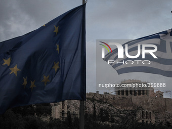 An EU and a Greek flag wave in front of the Parthenon in Acropolis. Athens, January 18, 2015. (