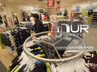 A woman walks into a clothing shop in Vigo on January 22, 2015
 (
